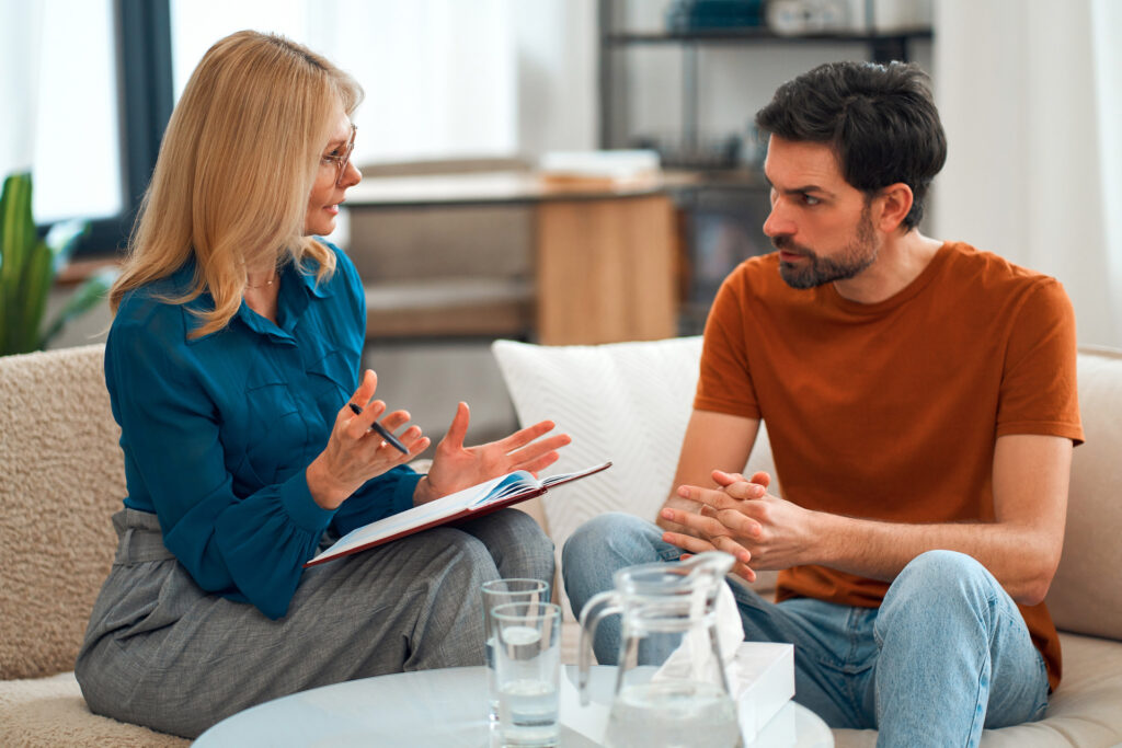 man speaking with therapist about shame