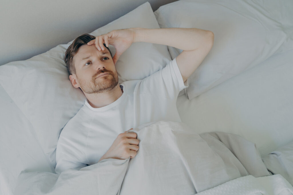 man restless from uncertainty weighing on his mind