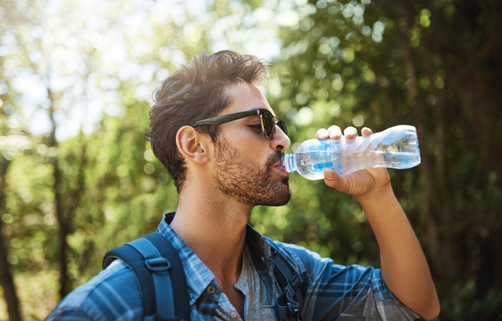 man drinking from water bottle