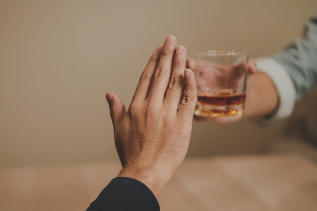 hand waving away offer of alcohol. living straight-edge lifestyle